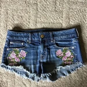Woman’s denim cut off shorts, with flower embroidery, size 2. American Eagle .